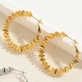 Macro shot of stylish gold and silver spiral hoop earrings with 925 hallmarked pins - Spiral Intertwined Hoop Style