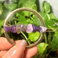 Golden round crystal hair clip with purple raw stones held by hand in nature - Gold Circle Amethyst Chips