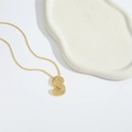 Gold chubby letter S pendant necklace with sparkling pavé crystals on white background - Letter S