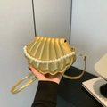 Golden shell-shaped crossbody bag with decorative pearl chain and slim strap - Gold