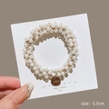 Elegant white faux pearl hair tie with a round gold metal charm for women's hair styling - Small Pearl Tag Scrunchie