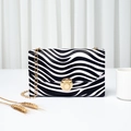 Zebra pattern rectangular crossbody bag with gold chain strap and metal clasp - Zebra Print
