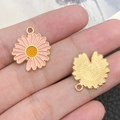 Pink enamel daisy flower charm with gold metal petals shown on fingers for size - 1Pc Pink Single-Sided Sunflower 18x20mm