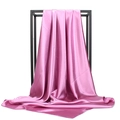 Close-up of lilac satin scarf draped on a black frame with elegant smooth folds - Dusky Pink