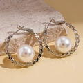 Minimalist silver geometric hoop earrings with pearls displayed on natural stone - Geometric Textured Pearl Hoop / Silver