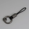 Porte-clés créatif en cuir tressé noir avec anneaux métalliques gris fusil polis - Noir + Gunmetal