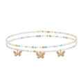 Détail macro d'une chaîne de corps perlée colorée avec pendentifs papillons dorés - #20 Style Papillon Texturé
