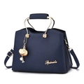 Navy blue lychee grain leather handbag with gold metal handles and pearl charm accessory - Royal Blue