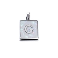 Macro shot of 22mm square silver stainless steel pendant with white shell letter G - Steel G