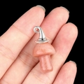 Pink quartz mushroom pendant with silver witch hat accessory held in hand - Gun Black Cap / Purple Aventurine