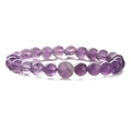 Macro shot of polished purple amethyst beaded bracelet showing natural stone textures - Purple Crystal