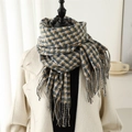 Classic British plaid scarf with tassels on a mannequin with a cream winter coat - Fog Blue