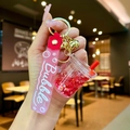 Detail of red glitter milk tea keychain with pink silicone wristband and golden bell - Red Luminous Bubble Bead Milk Tea Cup