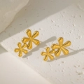 Gold hollow double flower earrings in polished stainless steel on a white stone base - Double Flower Studs