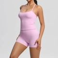 Detailed view of pink yoga set with spaghetti strap tank top and high-waist biker shorts - Sakura Pink