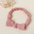Close-up of pink textured cotton bow headband with elastic wrinkled fabric detail - Dusty Pink