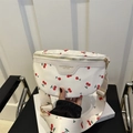 White leather chest bag featuring red cherry prints and matching wide shoulder strap - White