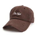 Close-up of distressed brim and New York embroidery on dark brown baseball cap - Coffee