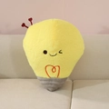 Cartoon light bulb plush pillow with heart antennas on a soft beige sofa - Light Bulb Shape (Light Bulb Pillow) / 35x25cm