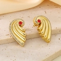 Macro detail of gold wing earrings with a central red stone and white crystal accents - Red (KE118712-SP)
