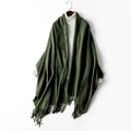 Dark green thick wool scarf with fringes over a white sweater in variant display - Army Green