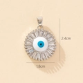 Detail view of evil eye sunburst pendant with dimensions 2.4cm by 1.8cm on beige background - A-3 Style/Sunburst Eye