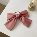 Pink satin oversized JK bow hair clip with spring fastener on white surface - Pink Large Hair Tie