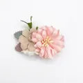 Detailed view of layered pink chiffon daisy hair clip with rhinestone and green fabric leaf - Style 1 (Pink & Beige Flower)