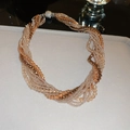Detail of multi-strand twisted bead necklace in gold and champagne with magnetic clasp - Multi-strand Twisted Rope Necklace / Brown