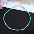 Close-up of handmade beaded necklace with turquoise stones and gold adjustable clasp - Style 1