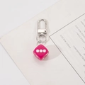 Detail of rose pink dice keychain with silver metal D-ring hook on a minimalist background - Rose Pink Dice