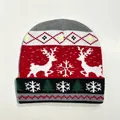 Close-up of knit Christmas beanie featuring reindeer and snowflake jacquard patterns - Style 13 (Red White Black Reindeer Tree Argyle)