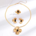 Detailed flat lay of golden flower jewelry set with necklace, ring and earrings - Black Bead Heart Radiant Flower Style (5665)