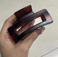 Macro detail of tortoiseshell pattern hair claw clip with rectangular hollow design - Matte Red Brown