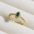 Macro shot of gold emerald ring with marquise-cut green zircon and clear accent stones - Exquisite Marquise Green Center Stone (款式6)