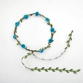 Handmade bridal flower crown with blue roses, white berries, and green leaf vine ties - Lake Blue