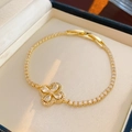 Close-up of gold-plated bracelet with zircon flower charm and adjustable chain detail - Gold