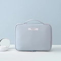 Light blue waterproof makeup bag with top handle and MAKEUP BEAUTY label on front - Light Blue Large