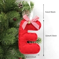 Red felt Christmas letter E ornament with plaid bow and bell hanging on tree branch - E-Bell