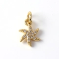 Macro shot of gold-plated starfish pendant with clear cubic zirconia and jump ring - Diamond Starfish