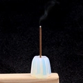 Incense burner carved from white translucent crystal stone with a burning incense stick - Opal (Synthetic)