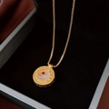 Detail of vintage gold necklace featuring a hollow filigree pendant with jade and red gem - Gold Jade Ruby Filigree Disc (11#)