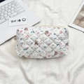 Close-up of quilted storage bag with cartoon bear prints and secure zipper closure - Snowflake Bear (White)