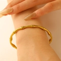 Chic gold-plated stainless steel bamboo joint bracelet shown on a female model wrist - Bamboo Design (WG-0726)