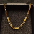 Detailed macro view of 18K gold plated chain featuring engraved dollar sign links - Necklace 3