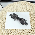 Detailed close-up of a black bow hair clip featuring sparkling rhinestones on a card - Mineral Grey Rhinestone - Classic