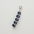 Handmade crochet flower keychain with dark blue petals and gold ring for bags - Arctic Blue
