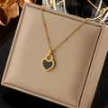 Golden heart-shaped lock necklace with black shell inlay and vintage beaded edge detail - Necklace