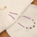 Handgefertigte Boho-Perlenkette mit lila Natursteinen auf einer Marmorplatte - Amethyst (Nr. 3)