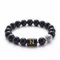 Minimalist black onyx beaded bracelet with natural white turquoise and golden letter N - Letter N